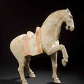 A painted red pottery figure of a prancing horse - Tang Dynasty