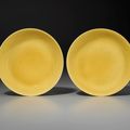 A pair of imperial yellow-glazed dishes, Zhengde six-character mark in underglaze blue within a double circle and of the period (1506-1521)