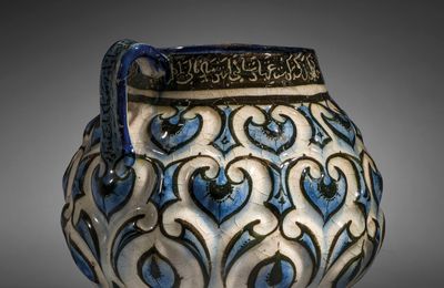 A Kashan moulded cobalt-blue, black and white jug, Central Iran, Early 13th century