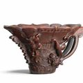 An exquisitely carved rhinoceros horn archaistic 'chilong' libation cup, 17th-18th century