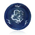 An exceptionally rare foliate rim dish decorated in white slip with relief dragon and clouds on a cobalt-blue glaze, Yuan Dynast