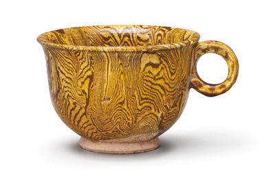 An amber-glazed marbled pottery cup, Tang dynasty (618-907)