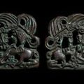 A pair of archaic bronze openwork 'eagle, tiger and ram' plaques, Ordos, circa 2nd-1st century BC