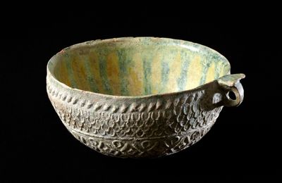 Earthenware cup with molded decoration and yellow and green glazes, Iraq or Syria, 8th-9th century