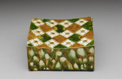Sancai tri-color glazed pottery pillow with impressed floral motif, Tang dynasty (618-907 CE)