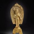 A magnificent inscribed gilt-bronze votive figure of Padmapani, Eastern Wei dynasty, dated wuding 2nd year, corresponding to 544