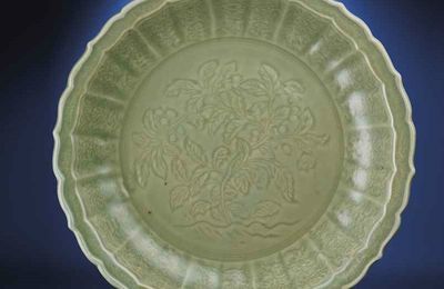 A fine and rare large carved 'loquats' Longquan celadon barbed-rim charger, Hongwu period (1368-1398) 