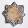 A Kashan lustre painted star-shaped tile with rabbits, early 14th century 