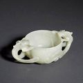 A translucent pale celadon jade, two handled cup. Ming Dynasty