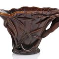 A well carved rhinoceros horn wine cup with lotos and millet, China, 18th ct