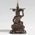 A pair of unusual bronze figural pricket candlesticks, 17th century