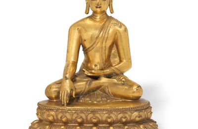 A rare Tibetan gilt-bronze figure of the seated Buddha, 14th-15th century