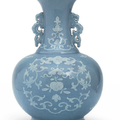 A white slip-decorated pale blue-glazed vase, Qianlong six-character seal mark in underglaze blue and of the period (1736-1795)