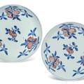 A pair of Ming-style blue and white and copper-red 'peach' dishes, Qianlong six-character seals mar and of the period