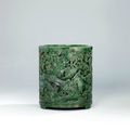 A finely carved and reticulated spinach green jade brush pot, Qianlong period (1736-1795)