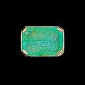 An engraved calligraphic emerald set in a gold ring, Persia, 19th-20th Century