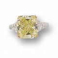 A cut-cornered rectangular modified brilliant-cut fancy yellow diamond and diamond ring