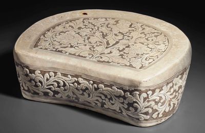 A rare Cizhou cream-glazed carved crescent-shaped pillow, Northern Song dynasty, 10th-11th century