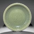 A fine and rare large Longquan celadon barbed 'Peony' dish, early Ming dynasty, late 14th-early 15th century