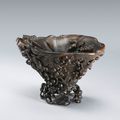 A large rhinoceros horn 'Squirrel And Grape' libation cup, Qing Dynasty, 17th-18th century