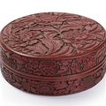 A very rare and fine round, carved cinnabar lacquer (tihong) box and cover with peony décor. China, six-character mark Xuande