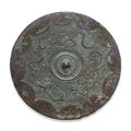 A bronze circular 'Dragon and Arc' mirror, Late Warring States Period-Early Western Han dynasty, circa 3rd century BC