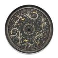 A gold and silver-inlaid black-ground bronze circular mirror. Western Han dynasty (206 BC-AD 8)
