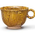 An amber-glazed marbled pottery cup, Tang dynasty (618-907)