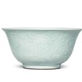 A very rare large celadon-glazed carved and moulded 'flowers and fruit' bowl, Yongzheng seal mark and of the period (1723-1735)