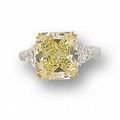 A cut-cornered rectangular modified brilliant-cut fancy yellow diamond and diamond ring