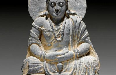 A grey schist figure of a seated Bodhisattva with kalasha, Gandhara, 2nd-3rd century