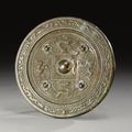 A bronze mirror with mythical beast decoration. Han Dynasty
