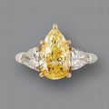 A pear-shaped fancy vivid yellow diamond and diamond ring