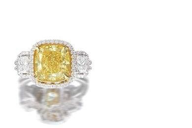 A fancy coloured diamond and diamond ring