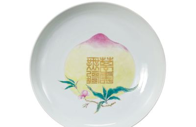 A rare ruby-ground famille rose ‘peach’ dish, Yongzheng six-character mark within a double circle and of the period (1723-1735)