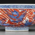 An iron-red-decorated blue and white 'Sea creatures' bowl, Qianlong six-character seal mark in underglaze blue and of the period