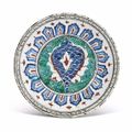 A rimless Iznik pottery dish, Ottoman Turkey, circa 1590