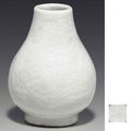 An unusual miniature white-glazed hu-form vase, Qianlong four-character incised seal mark and of the period (1736-1795)